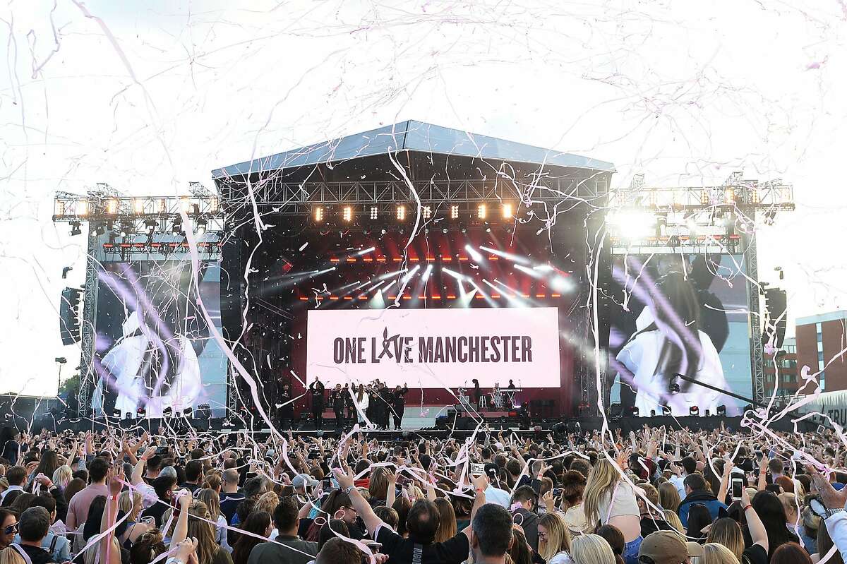 In this Sunday, June 4, 2017, handout photo provided by Dave Hogan for One Love Manchester, singer Ariana Grande, onstage in white, performs at the One Love Manchester tribute concert in Manchester, north western England, Sunday, June 4, 2017. One Love Manchester is raising money for those affected by the bombing at the end of Ariana Grande's concert in Manchester on May 22, 2017. (Dave Hogan via AP)