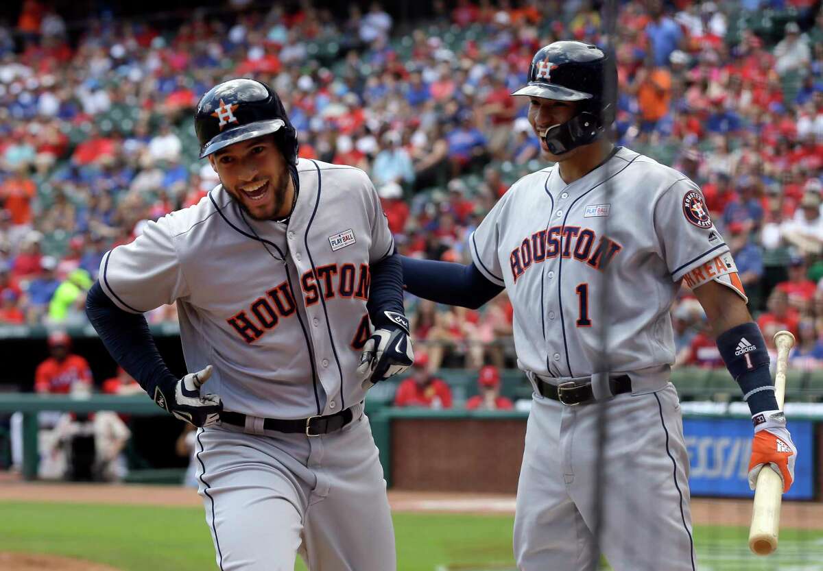 Houston Astros' George Springer (4) and Carlos Correa (1) celebrate Springer's solo home run that came off a pitch from Texas Rangers' Martin Perez in the first inning of a baseball game, Sunday, June 4, 2017, in Arlington, Texas. (AP Photo/Tony Gutierrez)