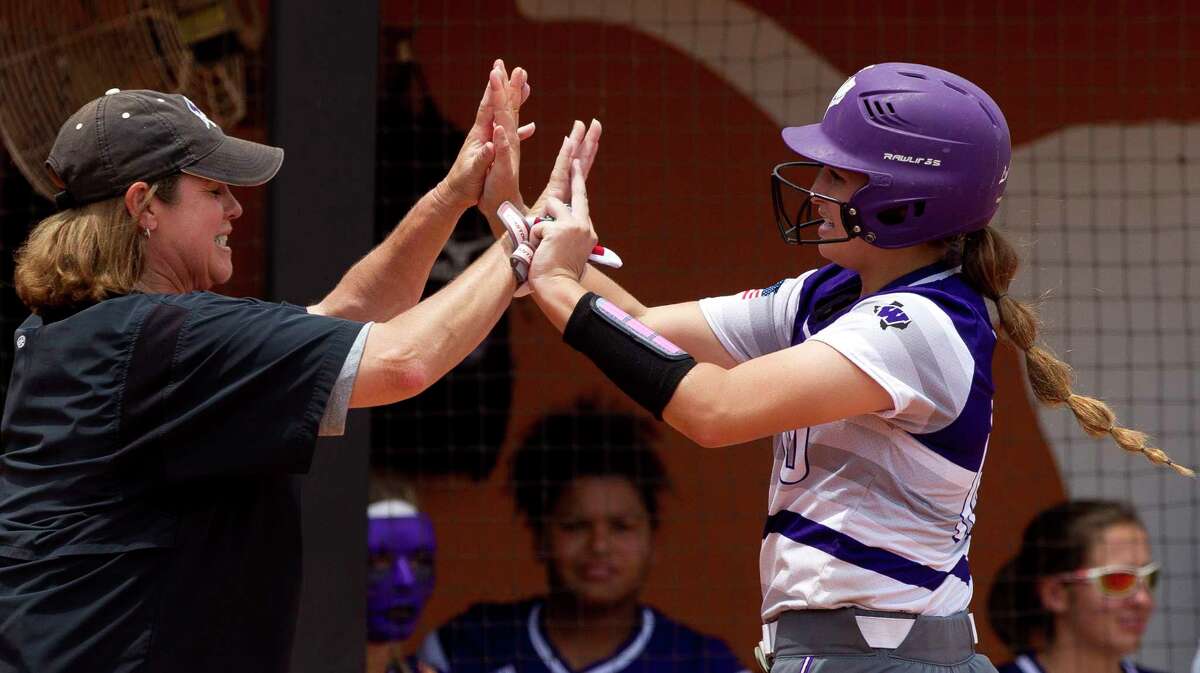 Casey Dixon #10 of Willis gets a high-five from head coach Stephanie Shelly after hitting an RBI double in the fifth inning of a Class 5A semifinal game during the UIL State Softball Championships at Red and Charline McCombs Field, Friday, June 2, 2017, in Austin.