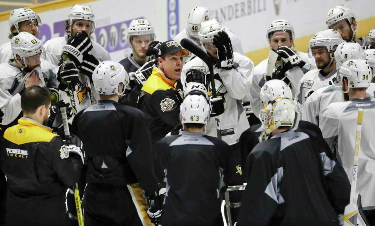Pittsburgh Penguins head coach Mike Sullivan, center, talks to his players during practice Sunday, June 4, 2017, in Nashville, Tenn. The Penguins and the Nashville Predators are scheduled to play Game 4 in the NHL hockey Stanley Cup Finals Monday. (AP Photo/Mark Humphrey)