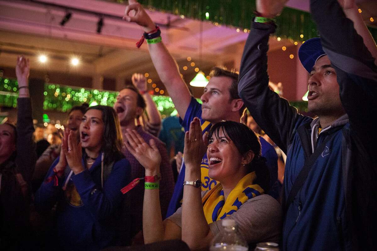 Warrior fan Neta Hamou of San Francisco (center) and friends watch the NBA Finals between the Golden State Warriors and Cleveland Cleveland Cavaliers at Paddy?s Pub during Colossal Clusterfest at Civic Center Plaza in San Francisco, June 4, 2017. (Peter DaSilva/Special to The Chronicle)