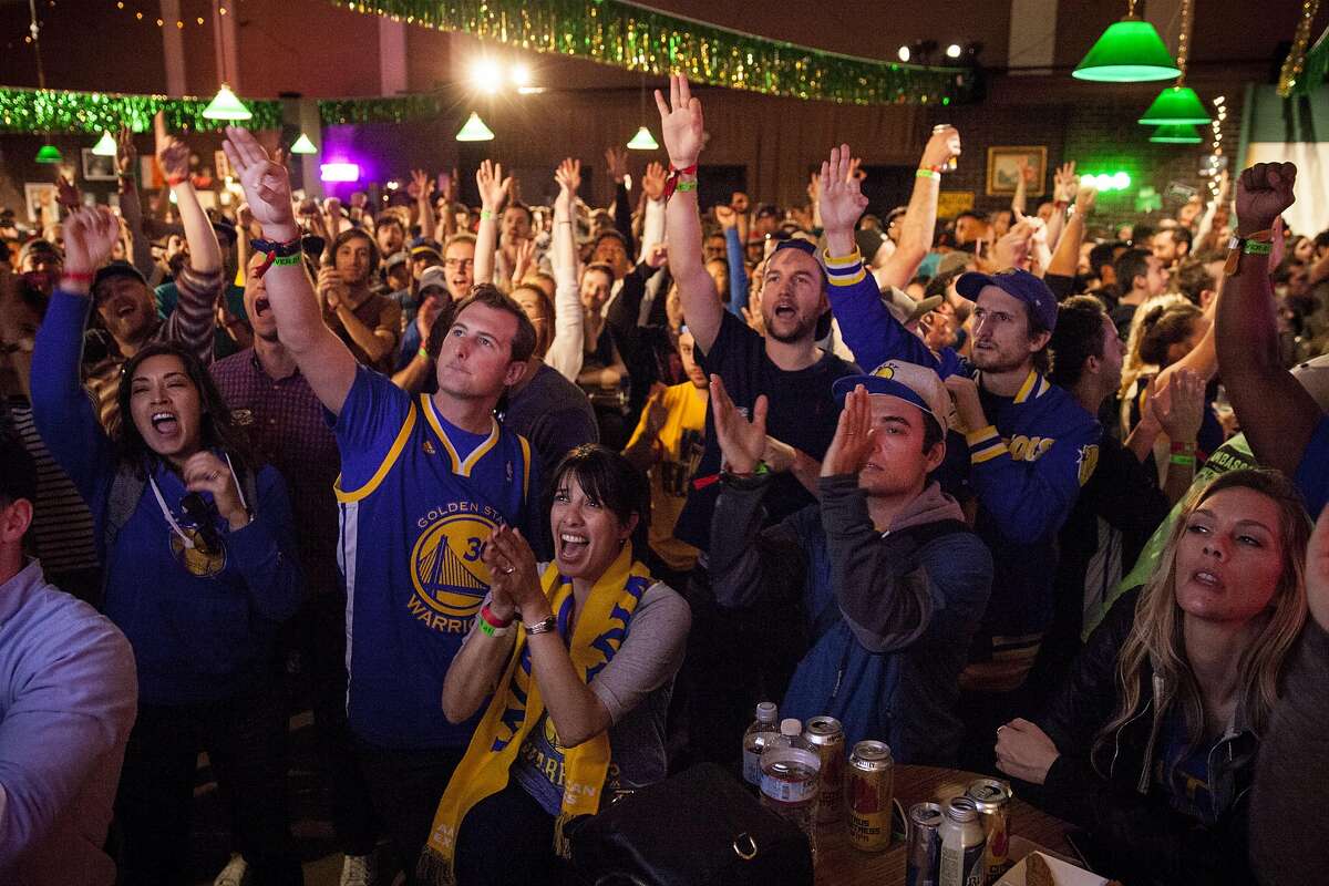 Warrior fan Neta Hamou of San Francico (center) and friends watch the NBA Finals between the Golden State Warriors and Cleveland Cleveland Cavaliers at Paddy?s Pub during Colossal Clusterfest at Civic Center Plaza in San Francisco, June 4, 2017. (Peter DaSilva/Special to The Chronicle)