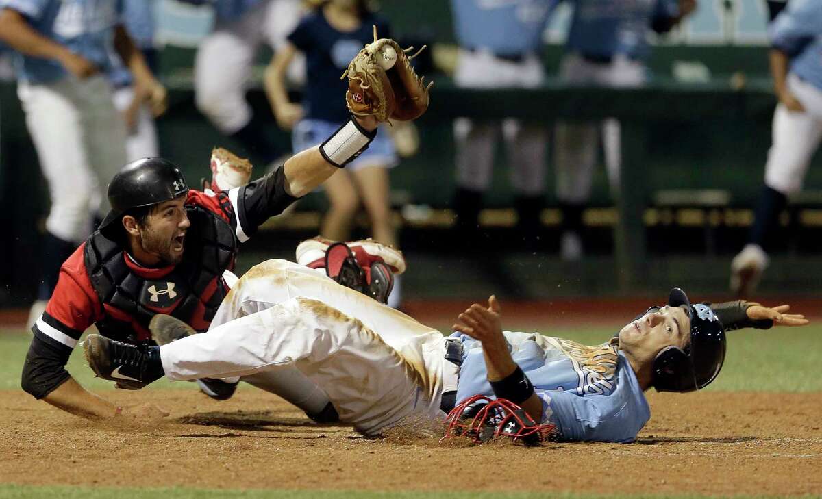 Davidson catcher Jake Sidwell reacts after making the tag on North Carolina's Brandon Riley at home plate during the ninth inning of an NCAA college baseball tournament regional game in Chapel Hill, N.C., Sunday, June 4, 2017. Riley was called out on the play. Davidson defeated North Carolina 2-1 to advance to the super regional. (AP Photo/Gerry Broome) ORG XMIT: NCGB115