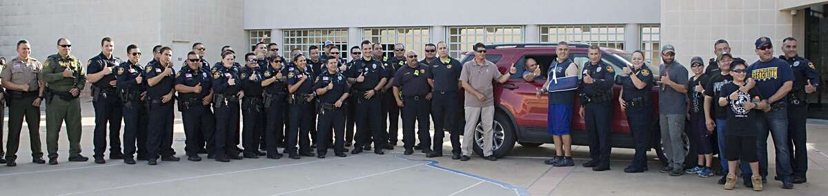 Officials welcome home wounded officers Mario Cásares and Arturo Vela at LPD headquarters on Sunday.