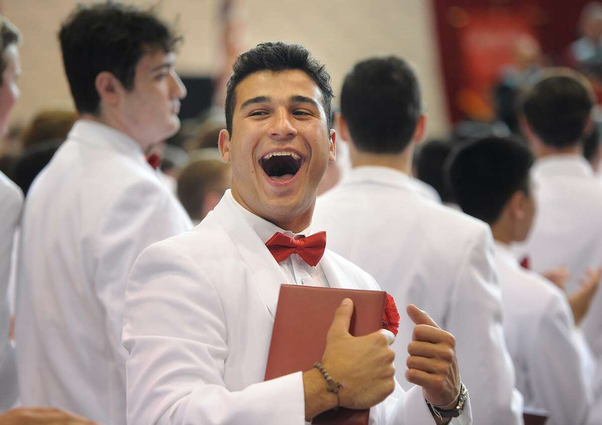 Michael Piroli celebrates after receiving his diploma at Fairfield Prep’s 75th Commencement Exercises at Fairfield University on Sunday.