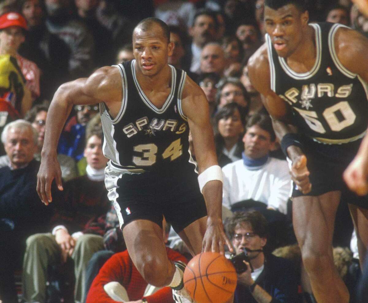 Terry Cummings of the Spurs, flanked by David Robinson (right), dribbles on a fast break during a 1995 road game.