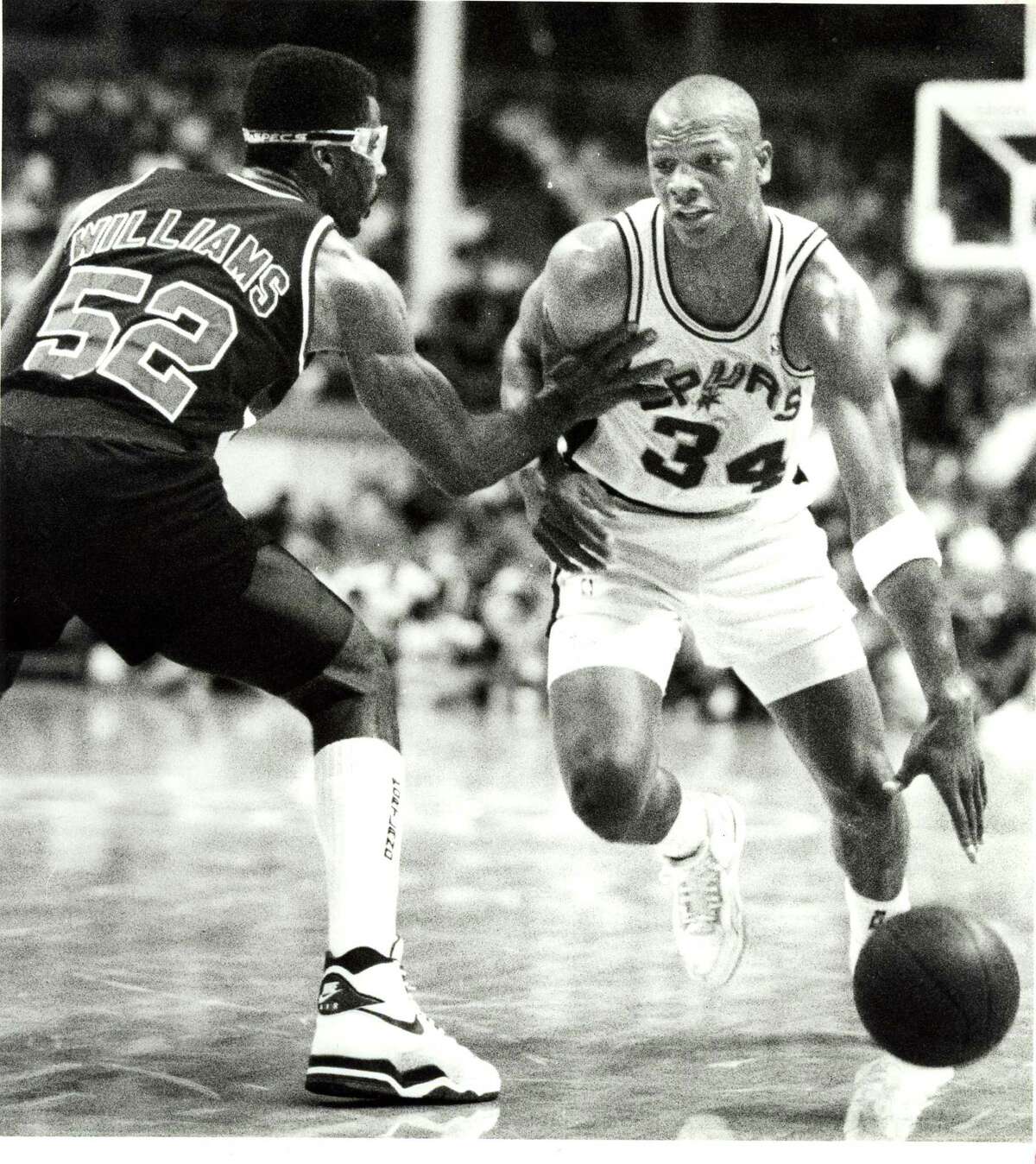 The Spurs' Terry Cummings drives against Portland's Buck Williams during an NBA game on May 10, 1990, at HemisFair Arena.