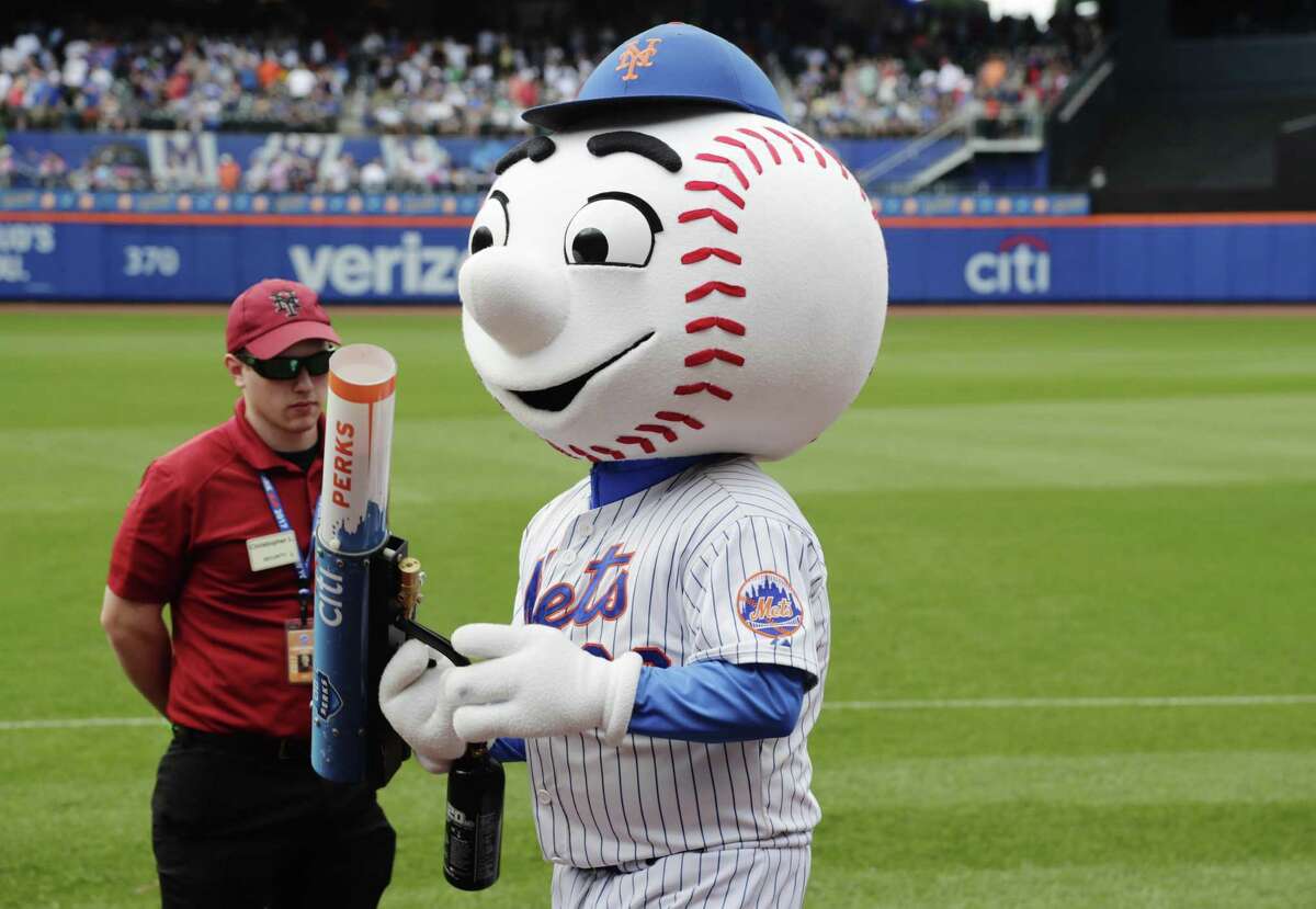 Mr. Met distributes T-shirts to fans during the sixth inning against the Milwaukee Brewers on June 1, 2017, in New York.