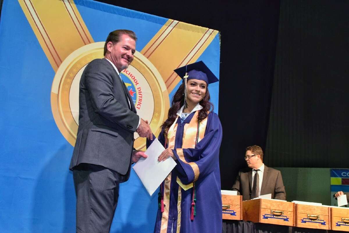 UISD Board Member Jud Gilpin gives Alina Marie Luna her high school diploma during the 2017 Alexander High School Commencement Ceremony held at the LEA Saturday May 03 2017.