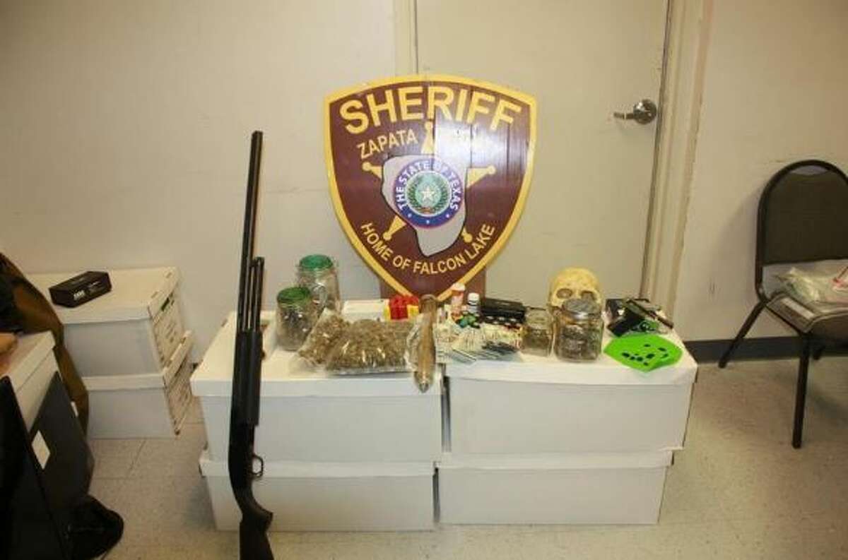 This photo shows the firearms and narcotics that were found in a home in the Lake Falcon Estates.  