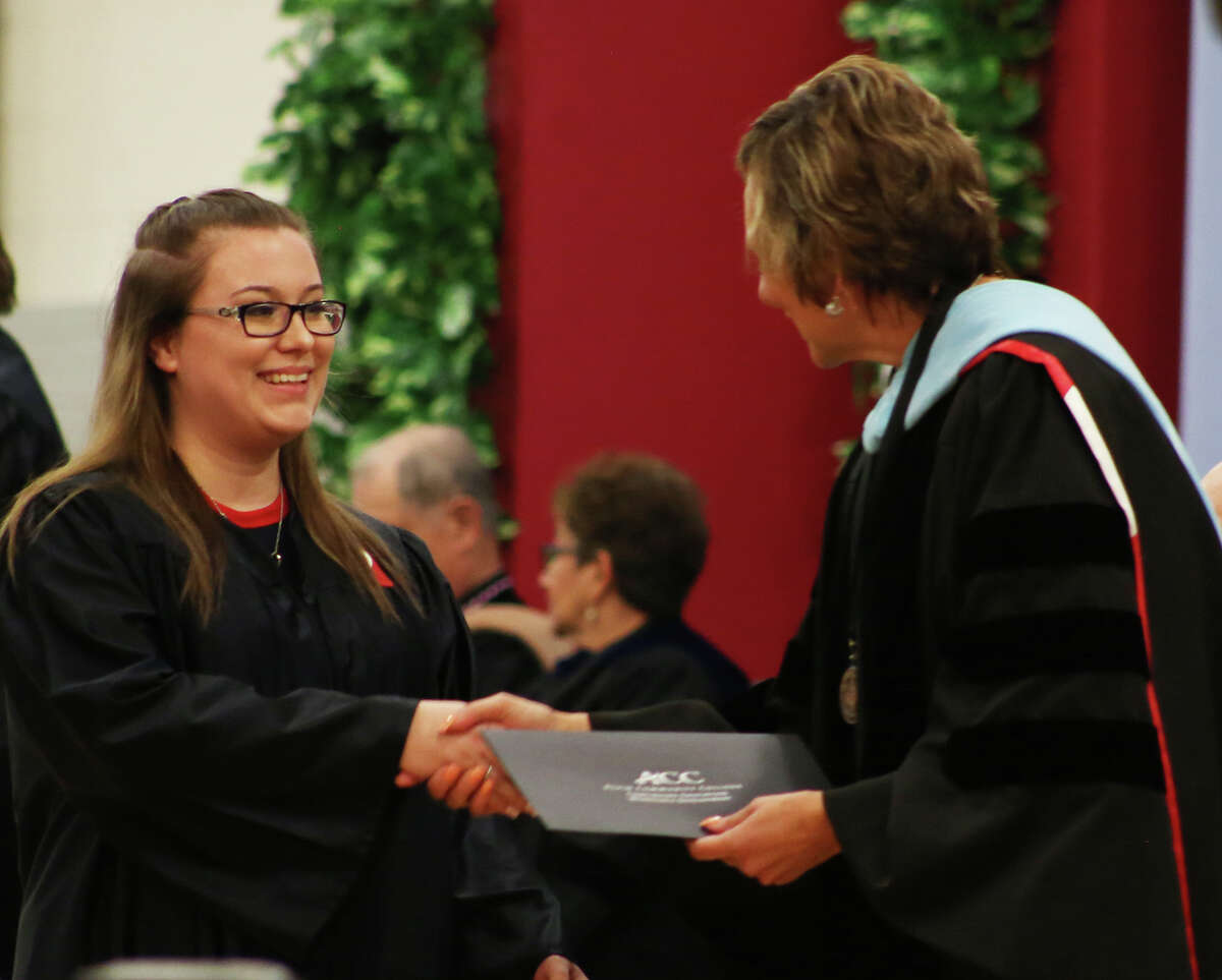 Alvin Community College certified medical assistant graduate Natalie Jackson, left, of Alvin receives her certificate from college President Christal M. Albrecht during the Continuing Education and Workforce Development commencement ceremony May 23. Photo courtesy Alvin Community College