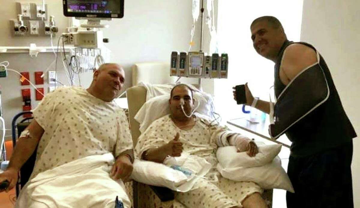 The officers injured in Friday's shootout pose in a hospital room.