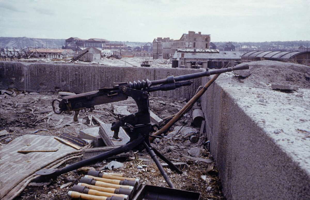 View of an abandoned German machine gun, and ammunition case on the roof of a building in the wake of the D-Day invasion by Allied forces during World War II, France, 1944.
