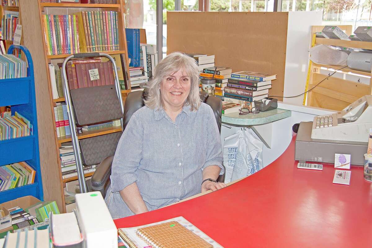 Elaine Higgins — who along with her husband, Ken, owns Caseville’s used book store — sits behind the desk near the entrance to the store.