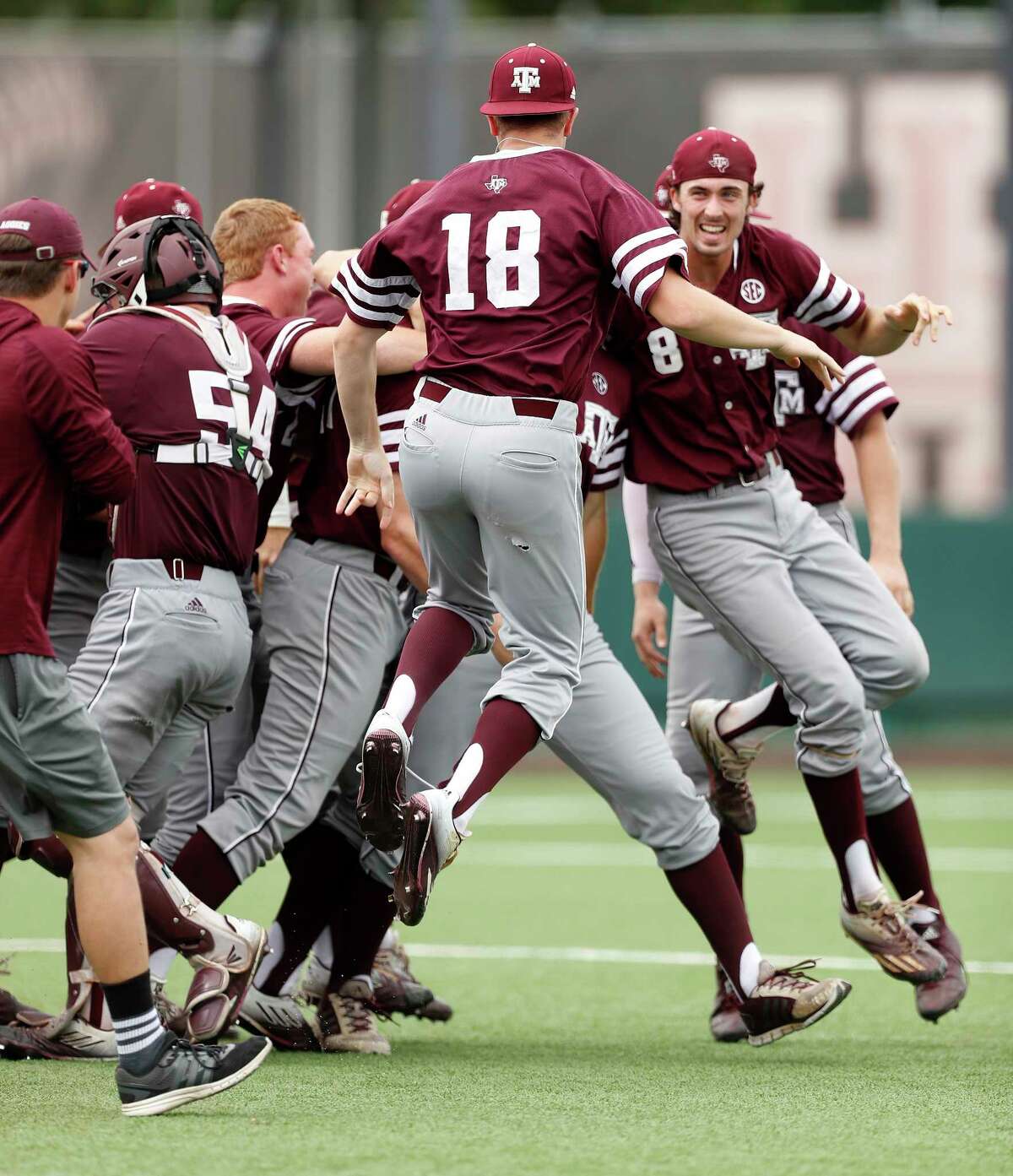 Texas A&M Braden Shewmake (8) and Nick Choruby (18) celebrates with teammates on the field after pulling out a 4-3 win over Houston Cougars during Game 6 of an NCAA Regional baseball game at Schroeder Park, in Houston, Monday, June, 5, 2017.