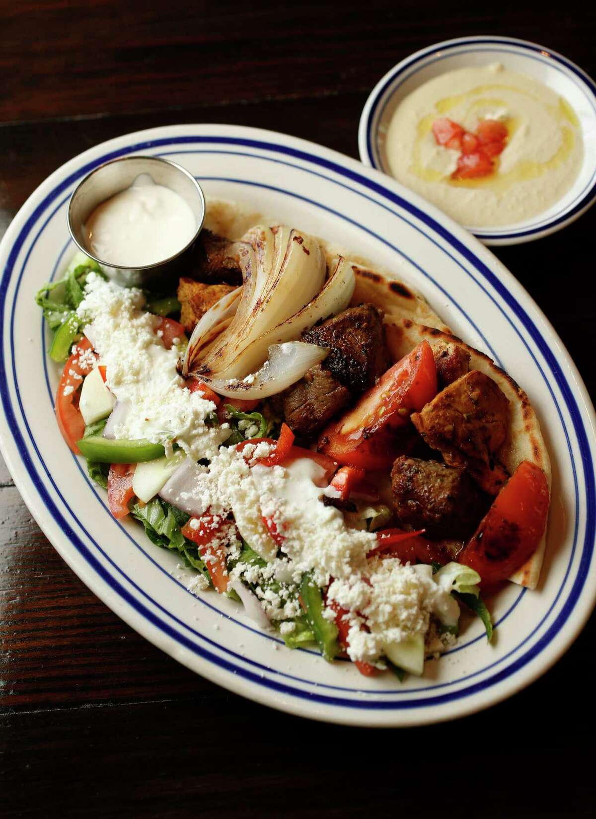 Island Grill offers the Kabob Plate - chicken breast and certified Angus beef with a side of hummus.