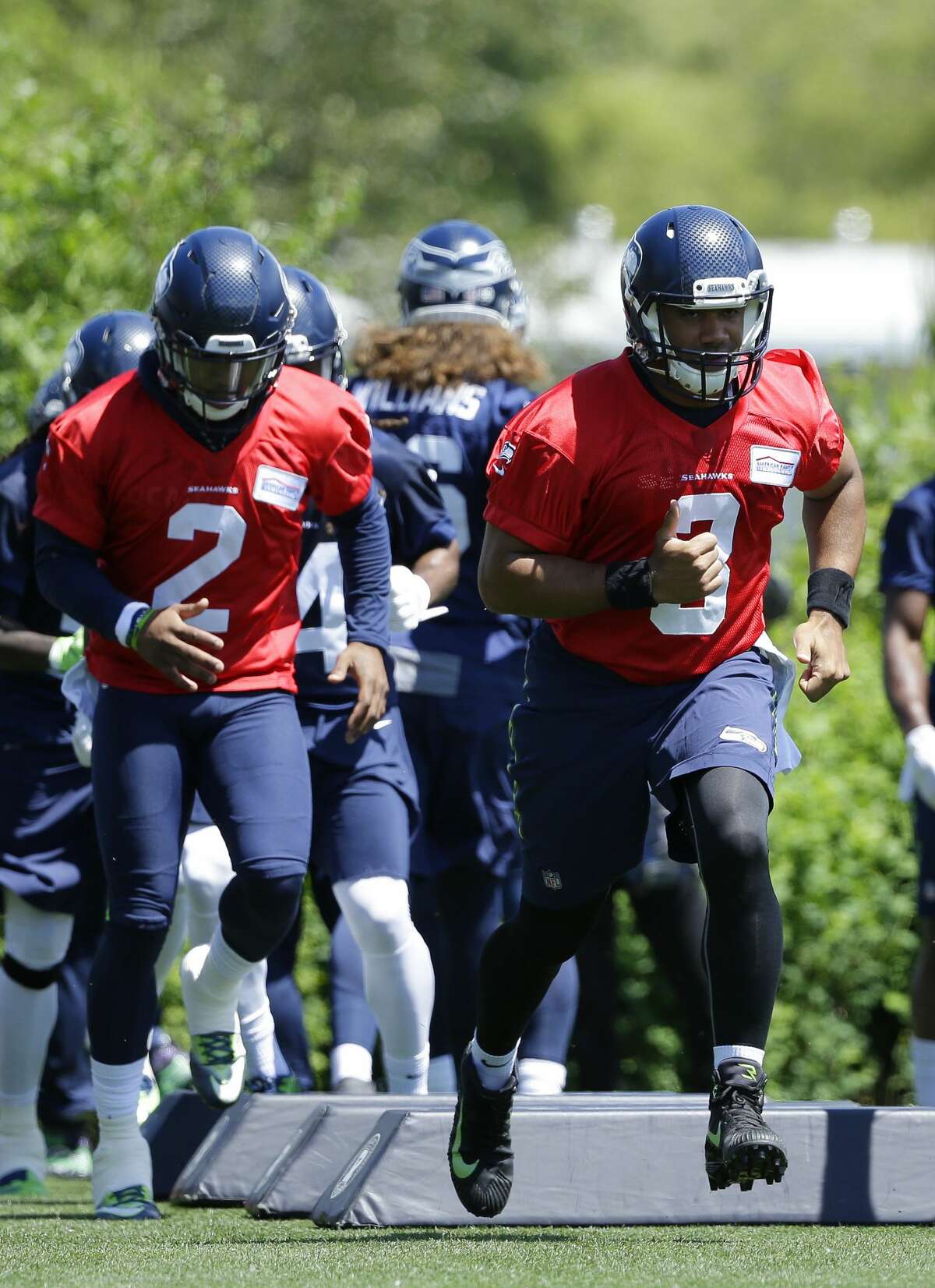 Seattle Seahawks quarterback Russell Wilson, right, and backup quarterback Trevone Boykin, left, take part in a drill during NFL football practice, Friday, June 2, 2017, in Renton, Wash. (AP Photo/Ted S. Warren)