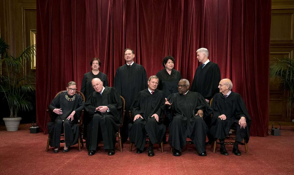 The justices of the U.S. Supreme Court sit for a group portrait in Washington, June 1, 2017. The fight over President Donald Trump�s travel ban reached the Supreme Court late Thursday night, in the form of three urgent requests from the Justice Department. Front row, from left: Associate Justice Ruth Bader Ginsburg, Associate Justice Anthony Kennedy, Chief Justice John Roberts, Associate Justice Clarence Thomas, and Associate Justice Stephen Breyer. Back row, from left: Associate Justice Elena Kagan, Associate Justice Samuel Alito, Associate Justice Sonia Sotomayor and Associate Justice Neil Gorsuch. (Doug Mills/The New York Times)