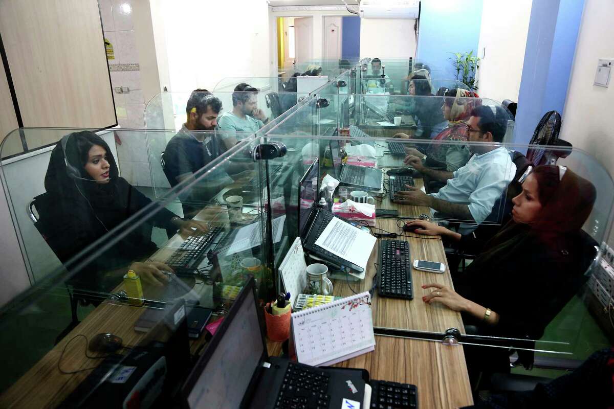 In this Sunday, May 22, 2017, photo, order processors of the Bamilo online shopping site work at their office in Tehran, Iran. Iran remains in many ways cut off economically from the rest of the world, fueling a surprisingly active local tech startup scene. ItÂ?’s driven by a growing number of Iranian millennials who see their country as a market ripe with opportunity. (AP Photo/Ebrahim Noroozi)