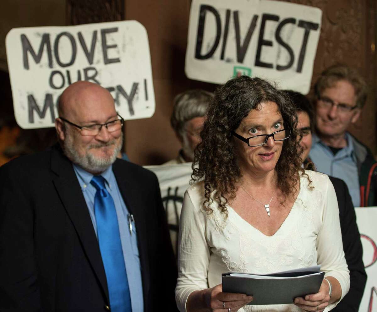 Rosendale, N.Y. town council member Jen Metzger, right, is joined by elected officials from across New York state during a press conference to release a letter from more than 200 elected officials across the state asking Comptroller DiNapoli to drop the $5 billion that the Common Retirement Fund invests in fossil fuels. Immediately following on President TrumpOs decision to exit the Paris Climate Agreement, Local elected officials are rallying to defend action on climate change. Governor CuomoOs strong commitment to climate action and NYC Mayor Bill De BlasioOs announcement that New York will continue to honor the Paris agreement confirms that the imperative for bold climate action now sits in the hands of state and local elected officials. Monday June 5, 2017 at the State Capitol in Albany, N.Y. (Skip Dickstein/Times Union)