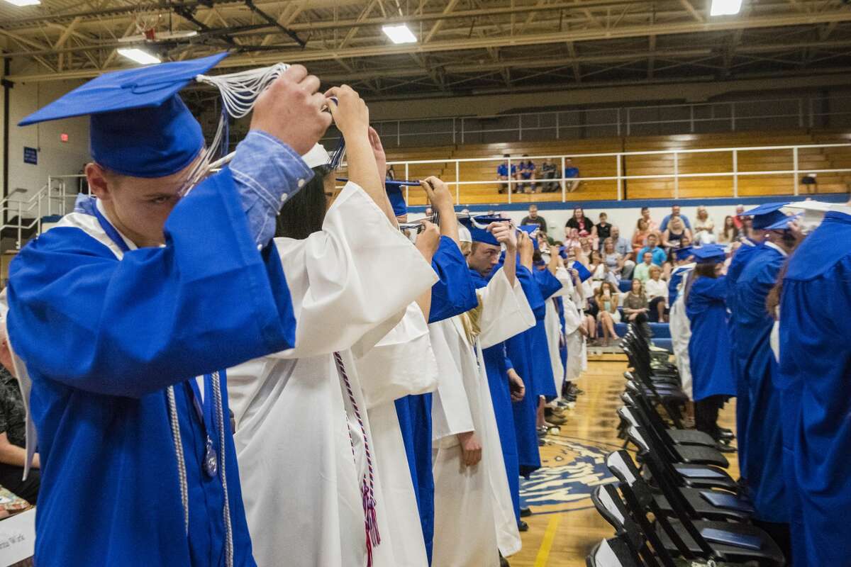 Chase Gordon and his fellow Coleman graduates turn their tassels during the graduation ceremony at Coleman High School on Sunday.