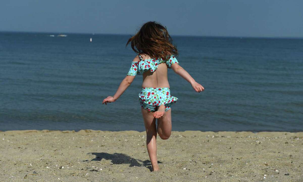 A girl runs to the water at Tods Point Beach on the Long Island Sound in Old Greenwich, Connecticut on May 18, 2017. CT DEEP says that even beach-goers are sound stakeholders and that the department wants to hear from them.