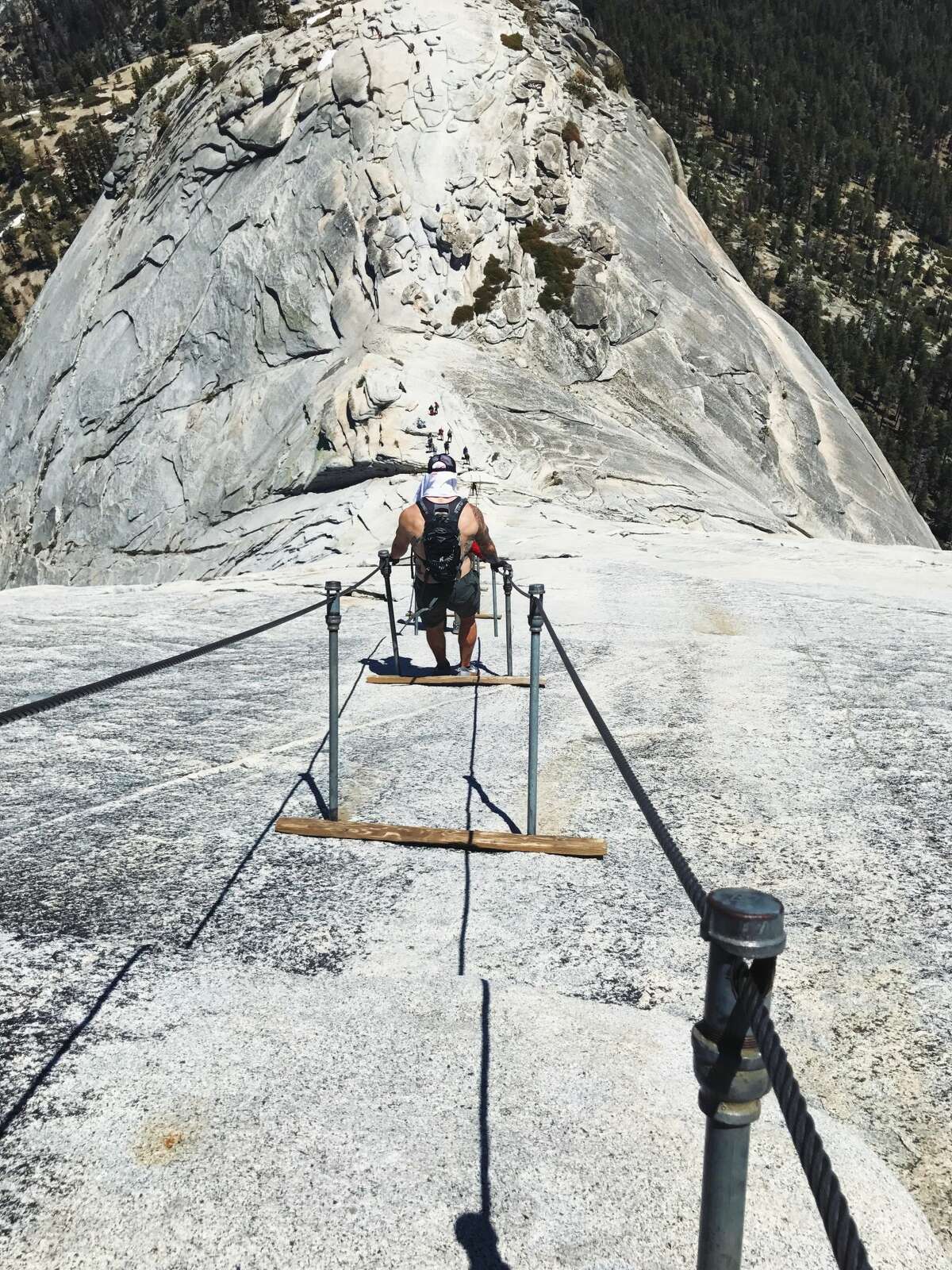 Hikers scale Half Dome via the cables on Sunday, June 4, 2017.