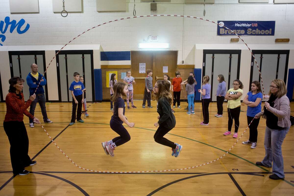 BRITTNEY LOHMILLER | blohmiller@mdn.net Eastlawn gym teacher Diane Sugnet, left, and Erin Evans of Midland spin two jump ropes while fifth-graders Kearstynn LaBerge, left, and Abby Wood jump double Dutch inside the school's gym on Thursday morning. Sugnet has coached the Eastlawn Elementary School jump rope team for 10 years. "It's is so good for the students," Sugnet said. "It gives them a skill, it's great cardiovascular exercise and when they get to perform it improves their self-esteem."