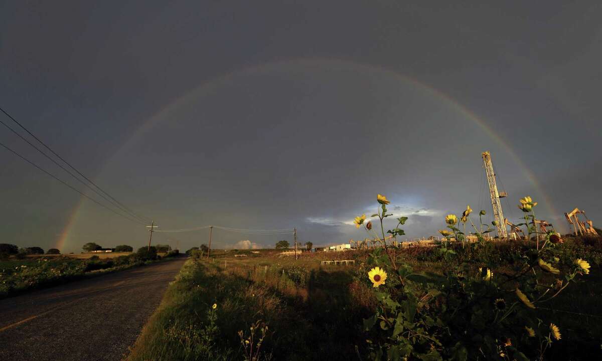 A rainbow appears over sunflowers in an oil field after a thunderstorm passed the area, Monday, June 5, 2017, in Karnes City, Texas. (AP Photo/Eric Gay)