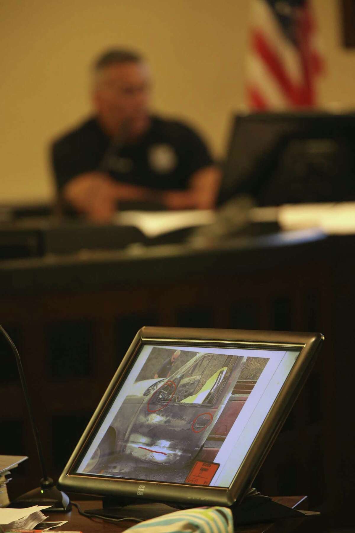 Photographs from the scene are introduced as evidence Tuesday during the second day of the murder trial of Joel Soto. San Antonio Fire Department Arson Investigator Juan Martinez is on the witness stand.