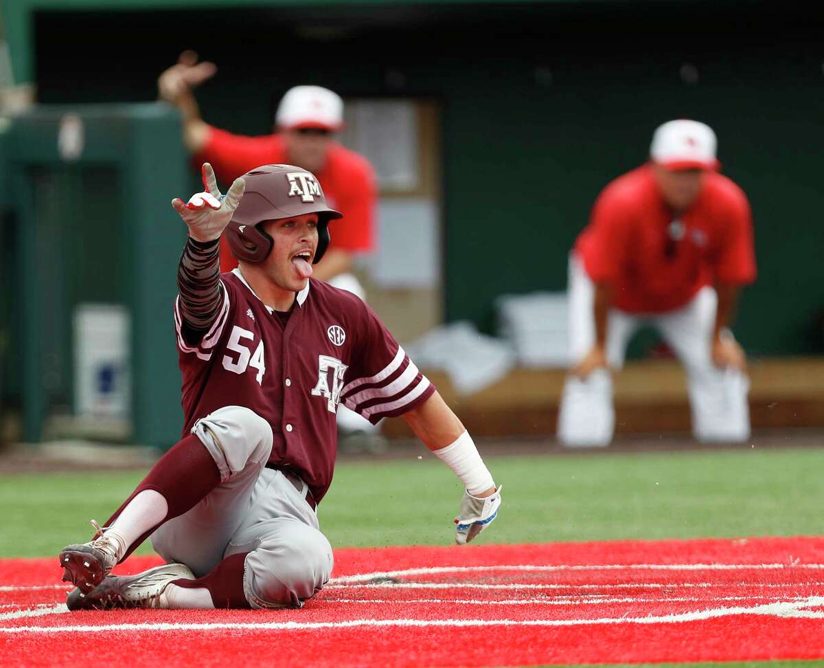 Cole Bedford makes a stylish slide to score for A&M in its regional-clinching win over UH on Monday.