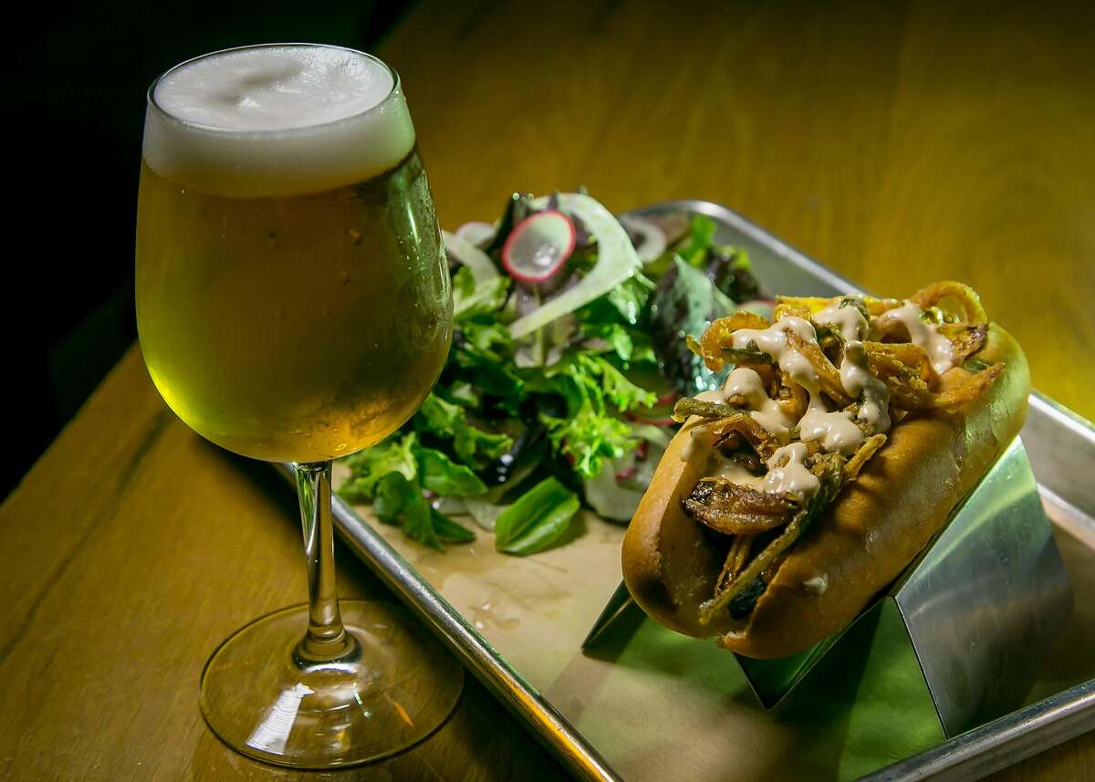 The Texas Ranger Dog with a salad and a Mikkeller "Hop On Drinkin Berliner" at Mikkeller Bar in San Francisco, Calif., is seen on June 6th, 2017.