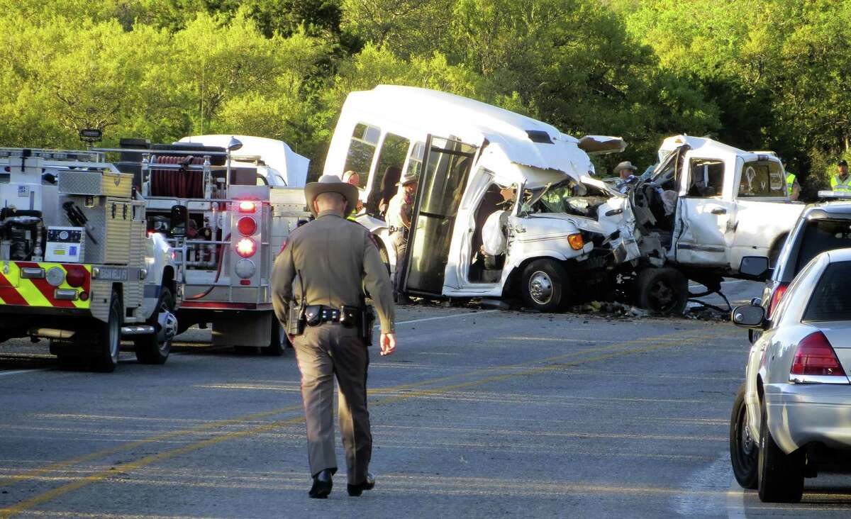 Authorities investigate after a deadly crash involving a van carrying church members and a pickup truck on U.S. 83 outside Garner State Park in northern Uvalde County, Texas, Wednesday, March 29, 2017. The group of senior adults from First Baptist Church of New Braunfels, Texas, was returning from a retreat when the crash occurred, a church statement said. (Zeke MacCormack/The San Antonio Express-News via AP)