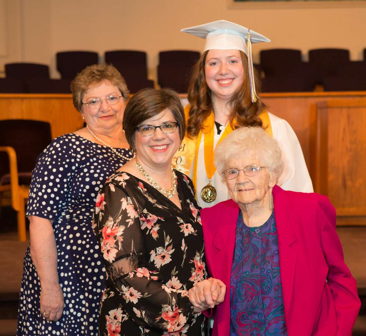 From left: Sharon McClain, Amy Kellogg, Emily Kellogg and Donna Scott pose for a portrait following Calvary Baptists Academy graduation. All four women were valedictorians of their high school class.