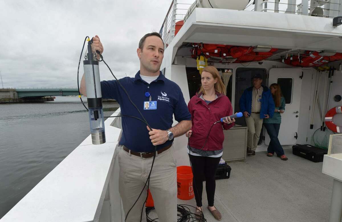 Maritime Aquarium research scientist Dave Hudson and Harbor Watch Director Sarah Crosby demonstrate the testing the groups will conduct as part of the Unified Water Study organized by Save the Sound during a news conference Tuesday on the aquarium's research vessel, Spririt of the Sound, at the aquarium in Norwalk.