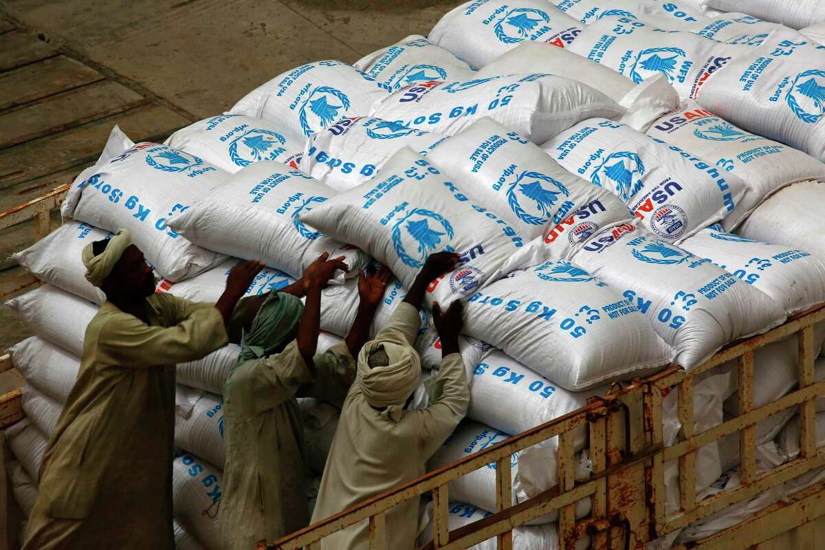 Sudanese workers in May offload U.S. aid destined for South Sudan from the World Food Programme (WFP) at Port Sudan. (Ashraf Shazly/AFP/Getty Images)