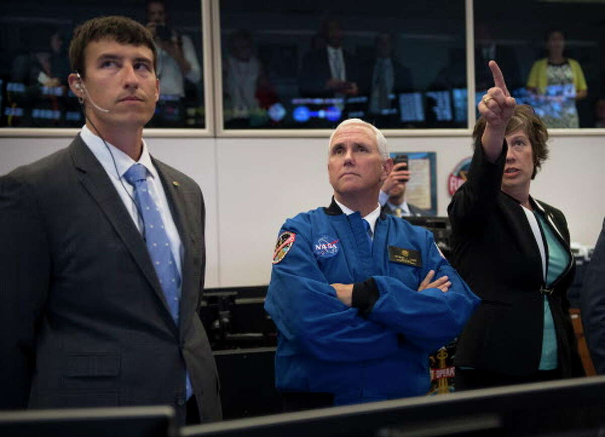 Vice President Mike Pence, center, listens to NASA Deputy Chief Flight Director Holly Ridings, right, and NASA Flight Director Rick Henfling during a tour of the Christopher C. Kraft Jr. Mission Control Center in Houston on Wednesday, June 7, 2017. NASA chose 12 new astronauts Wednesday from its biggest pool of applicants ever, selecting seven men and five women who could one day fly aboard the nation's next generation of spacecraft. (Michael Ciaglo/Houston Chronicle via AP)
