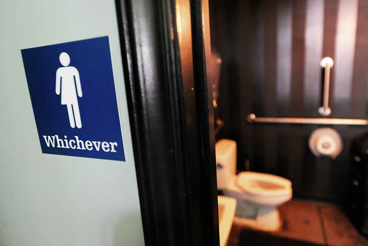 A gender neutral sign is posted outside a bathrooms at Oval Park Grill on May 11, 2016 in Durham, N.C. (Photo by Sara D. Davis/Getty Images)