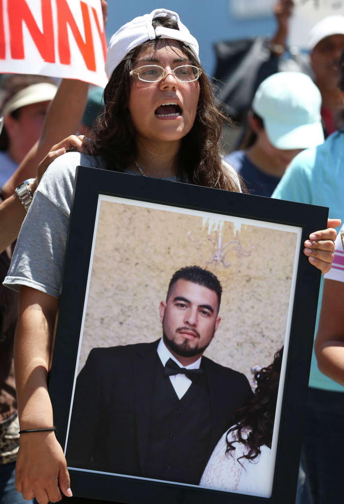 Maria Toval, wife of deceased John Hernandez, holds a photograph of Hernandez while marching from Guadalupe Plaza Park to to the Harris County Criminal Justice Center with more than a hundred protesters Wednesday, June 7, 2017, in Houston. Hernandez was killed by Terry Bryan Thompson, husband of Harris County Sheriff's Deputy Chauna Thompson, with a choke hold last week outside of a Denny's restaurant after the two got into a fight. Toval was also at the scene. The march was calling to seek justice for Hernandez.