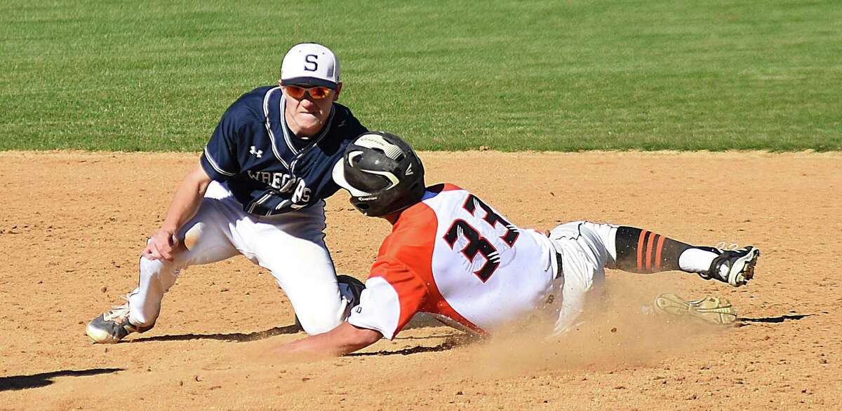 Staples second baseman Drew Rogers, left, tags out Ridgefield’s Nicholas Hanna at second base on a stolen-base attempt.