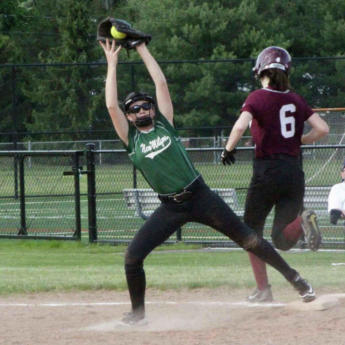 The New Milford High School JV softball team fell 6-3 to Bethel May 19. Second baseman, freshman Paige Duffany, covers the bag at first and makes the catch to get the out at first.