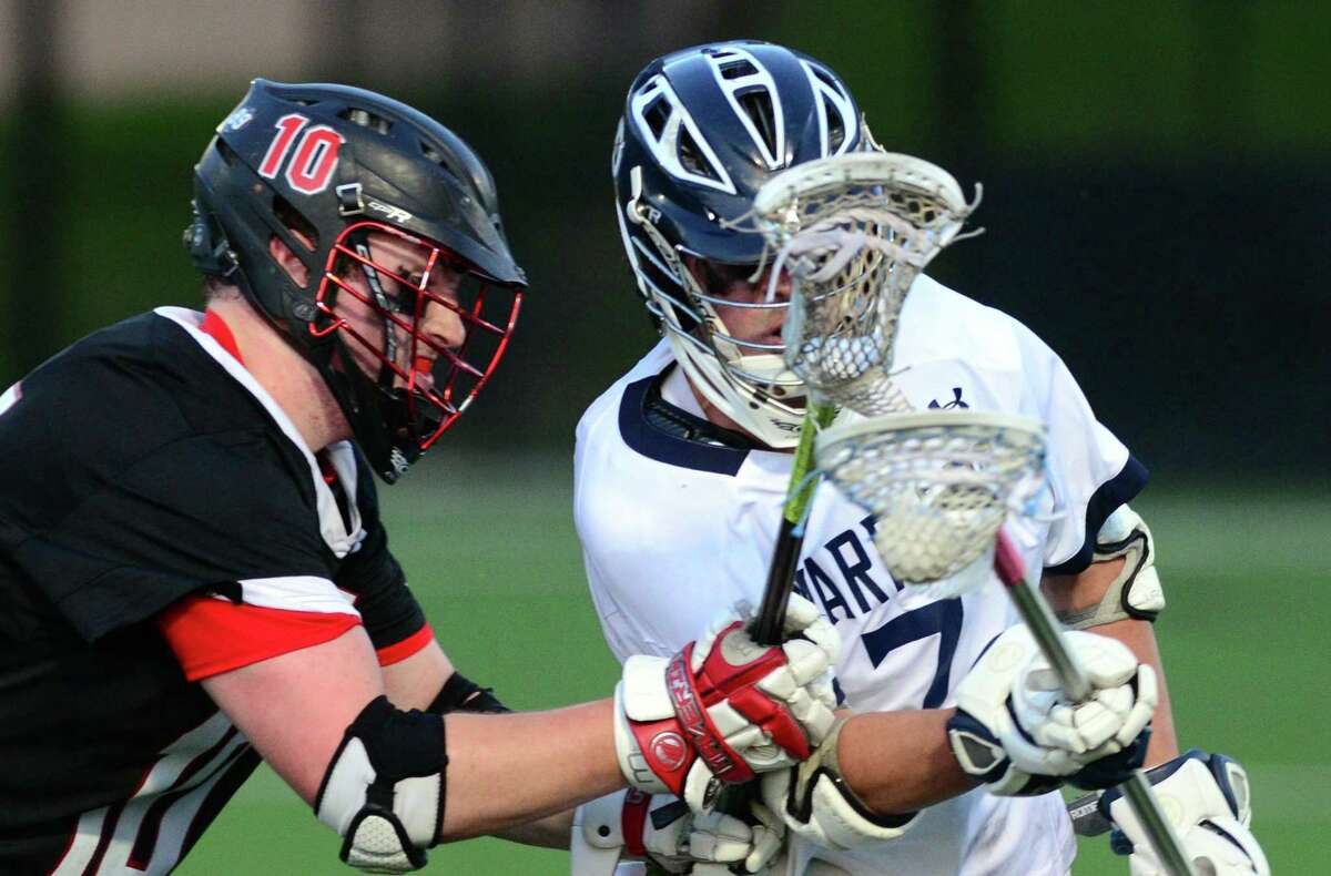 Cheshire's Daniel Covel, left, tries to cut off Wilton's Joseph Scarfi during Class L boys lacrosse semi-final action against Cheshire in at Fairfield University in Fairfield, Conn. on Wednesday June 7, 2017.