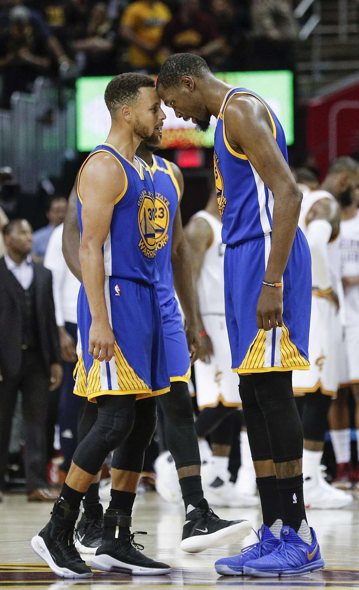 Golden State Warriors' Stephen Curry and Kevin Durant touch heads in the fourth quarter during Game 3 of the 2017 NBA Finals at Quicken Loans Arena on Wednesday, June 7, 2017 in Cleveland, Ohio