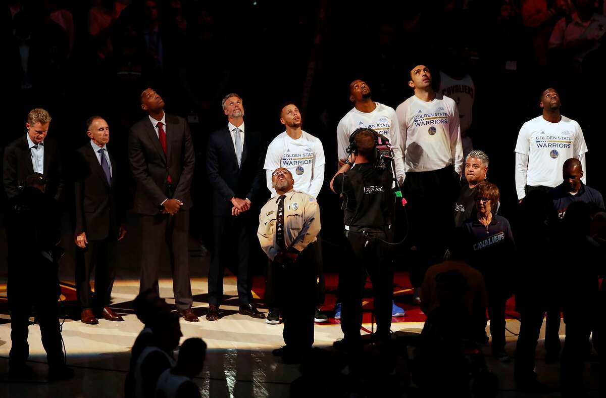Golden State Warriors line up for National Anthem before Warriors' 118-113 win over Cleveland Cavaliers in Game 3 of the NBA Finals at Quicken Loans Arena in Cleveland, Ohio, on Wednesday, June 7, 2017.