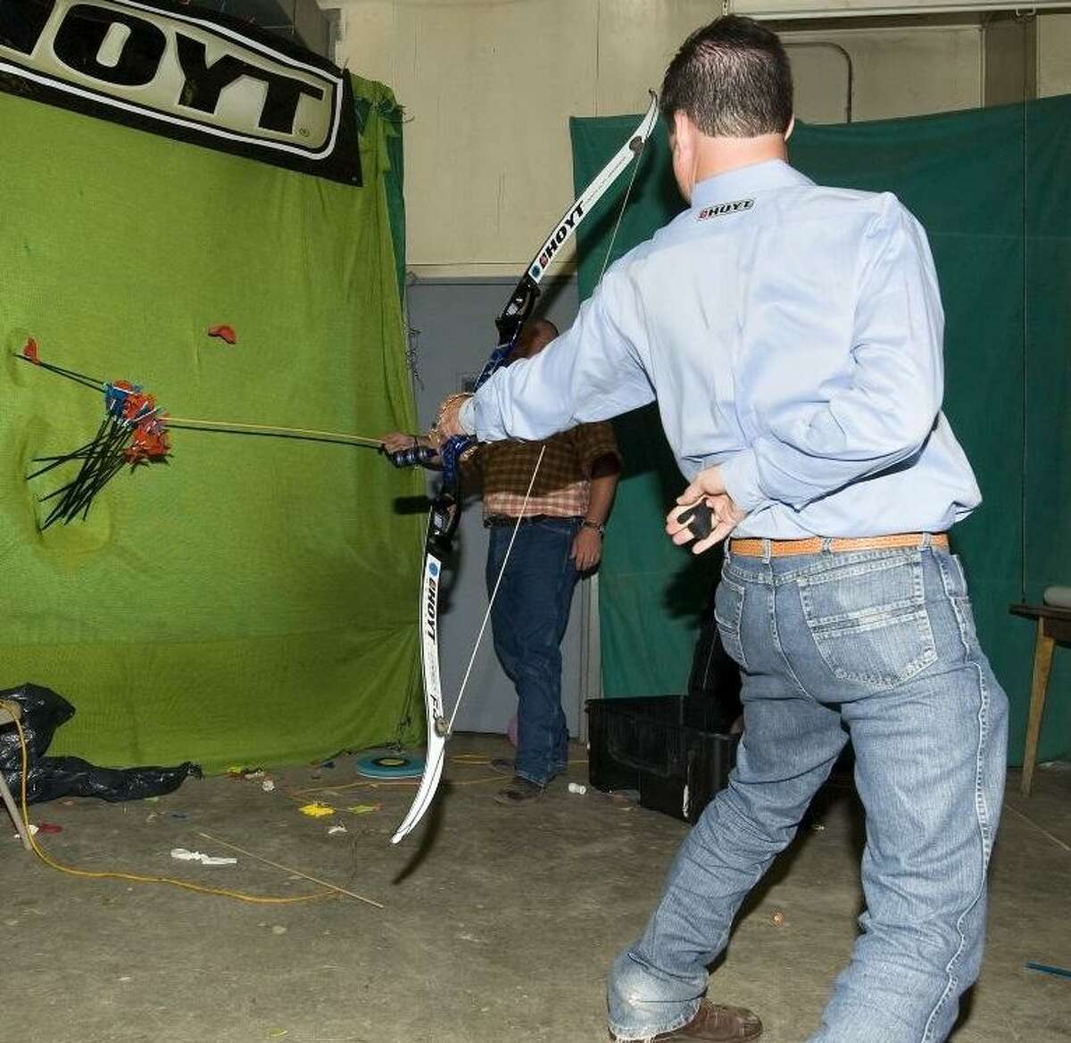 Professional exhibition archery shooter Frank Addington Jr. fires 12 arrows at once.