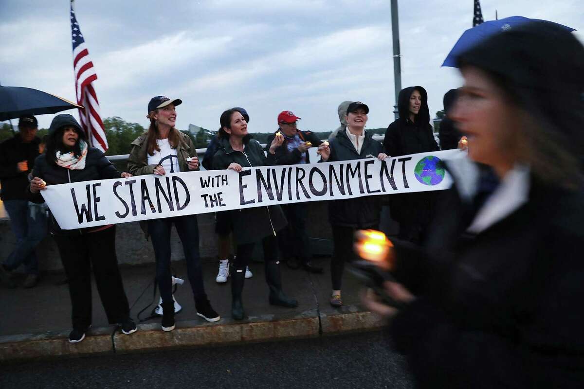 On Post Road Bridge, Westporters protest President Donald Trump's decision to withdraw the United States from the Paris climate accord at a June 4 vigil and rally.
