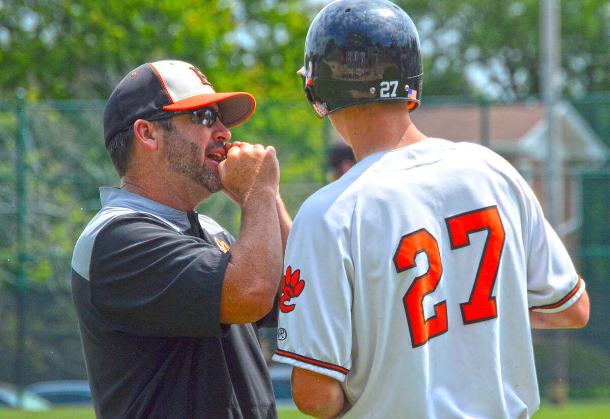 Edwardsville coach Tim Funkhouser, left, talks to third baseman Cole Hampton during the Class 4A Bloomington (Illinois Wesleyan) Sectional championship game on June 3.