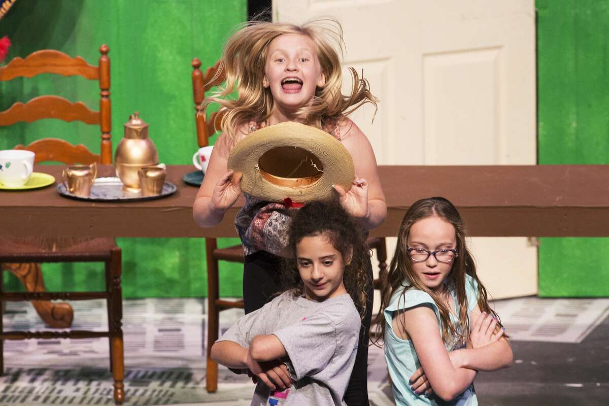 Sydney Cluff, as Mad Hatter, Paloma Jolly, as March Hare, Allison Nussear, as Dormouse, perform during the rehearsal of the Peanut Gallery's production of "Dorothy in Wonderland" at The Midland Center for the Arts on Wednesday.
