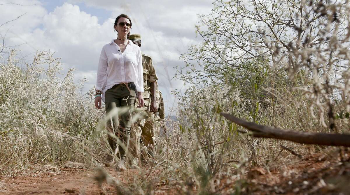 In this image made from video provided by the International Fund for Animal Welfare (IFAW) taken on Feb. 26, 2016, Faye Cuevas of IFAW and a field unit of the Kenya Wildlife Service (KWS) test a smartphone app used to collate poaching incident reports, in Tsavo East National Park, Kenya. A decorated war veteran with two decades� experience in military intelligence, Lt. Col. Faye Cuevas spent half her career providing intelligence support to U.S. counter-insurgencies in Iraq, Afghanistan and the Horn of Africa. Now she is using her expertise to fight a different kind of conflict: the war on wildlife poaching. (Nina Schwendemann/IFAW via AP)