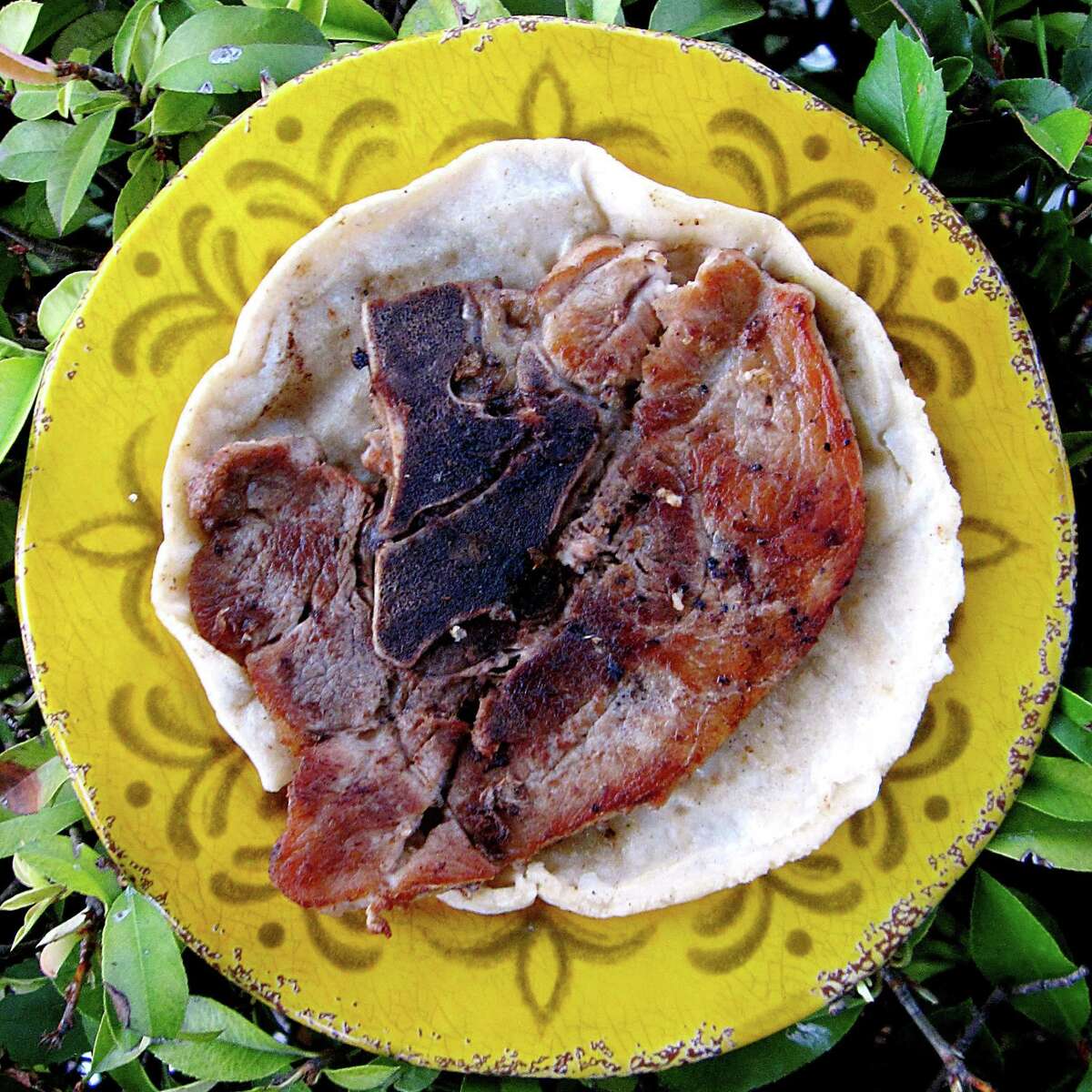 Pork chop taco on a handmade corn tortilla from Rocky's Taco House.
